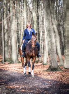 young woman riding through the forest young woman riding through the forest